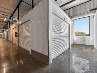 Interior hallway with storage units and natural light from a window.