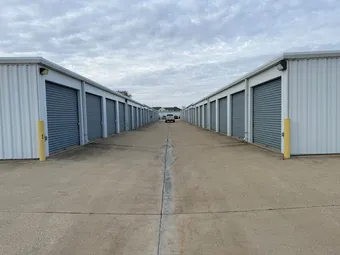 Drive-up storage units with wide drive aisles