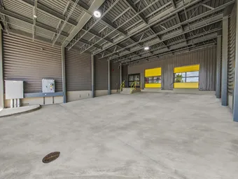 Spacious indoor loading bay with yellow roll-up doors.