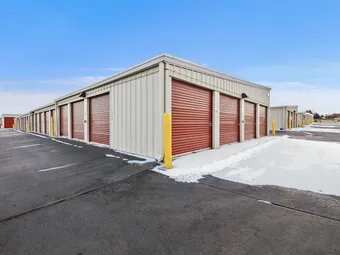 Outdoor storage units with snow along the access lanes.