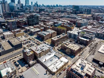 Aerial view of a city with storage facility visible among buildings