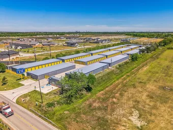 Aerial view of storage facility with multiple rows of drive-up units.