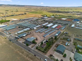 Aerial view of self storage facility with various unit buildings and vehicle storage.