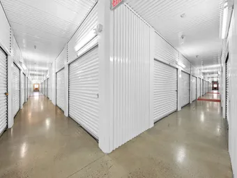 Indoor climate-controlled storage unit hallway.