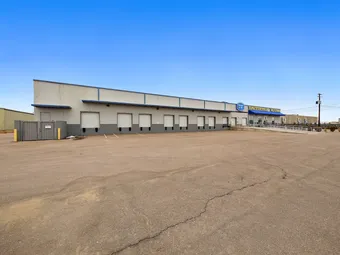 Panoramic view of self storage facility building and parking lot