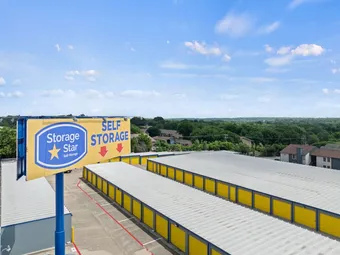 Large 'Storage Star Self Storage' sign with storage buildings in background.