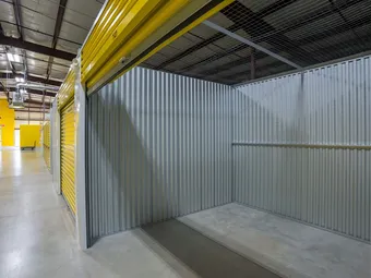 Interior of empty storage unit with overhead rolling door