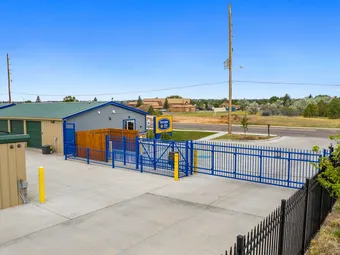 Exterior view of the storage office, gate, and perimeter fence.