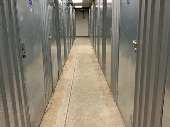 Interior hallway with rows of corrugated metal storage unit doors