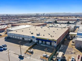 Aerial view of self storage facility with city skyline in distance