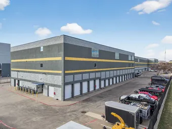 Exterior view showing drive-up access to ground-level storage units.