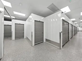 Clean, well-lit interior hallway with multiple storage units.