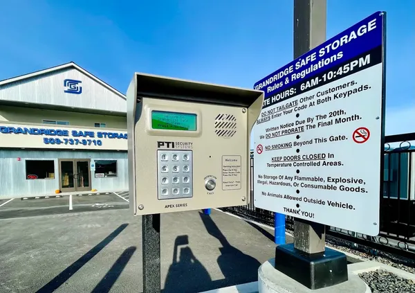 A secure keypad entry system and Grandridge Safe Storage rules sign in front of the facility office
