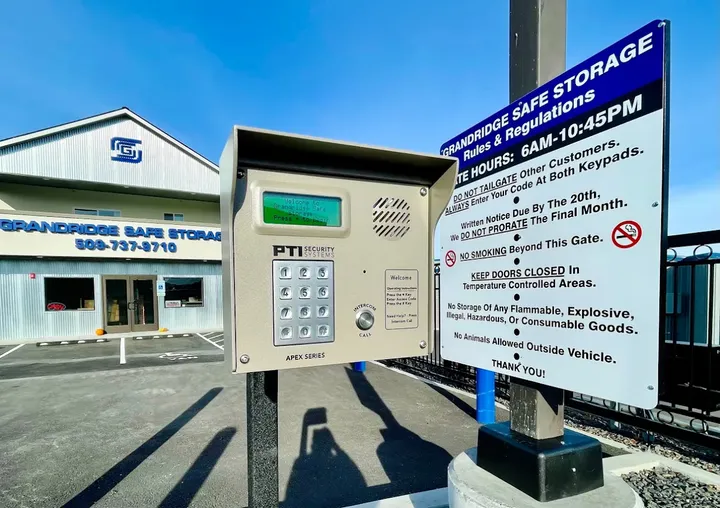 A secure keypad entry system and Grandridge Safe Storage rules sign in front of the facility office