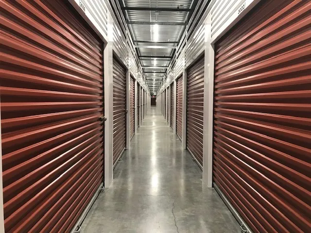 Interior hallway lined with red storage unit doors