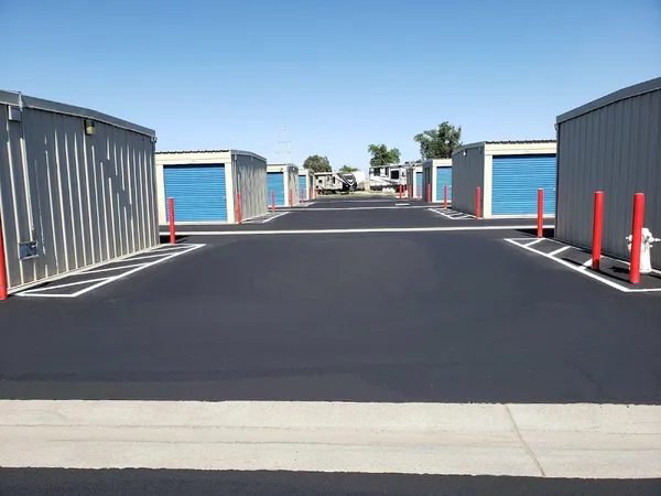Paved drive aisle between storage unit buildings