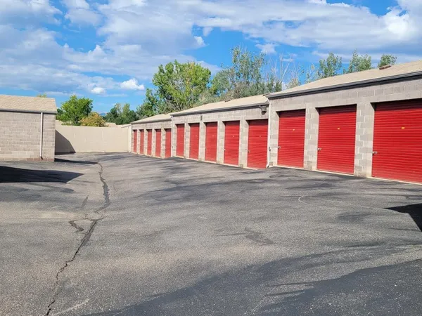 Exterior storage building with red roll-up doors