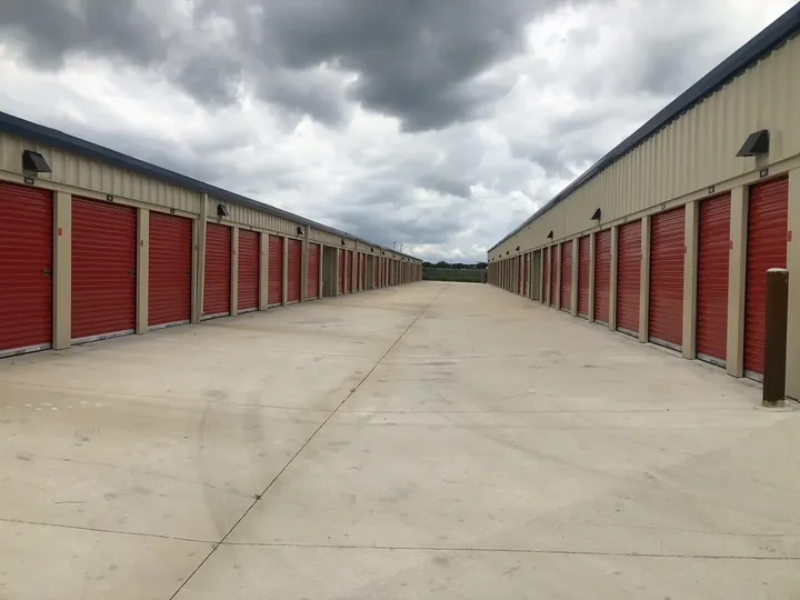 Drive-up storage units with red roll-up doors