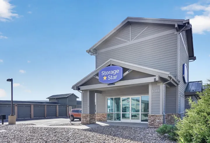 Office at Storage Star Self-Storage in Park City, UT, featuring gray siding, a sidewalk leading to a paved parking lot, and drive-up storage units