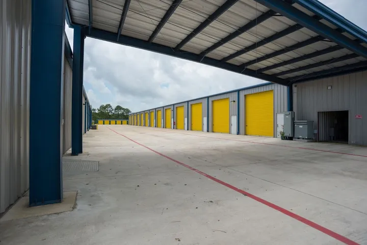 Row of yellow drive-up storage unit doors