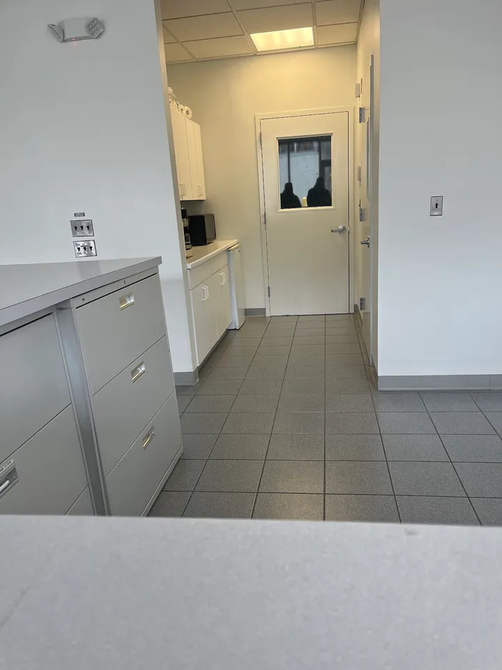 Office interior showing a storage cabinet and doorway