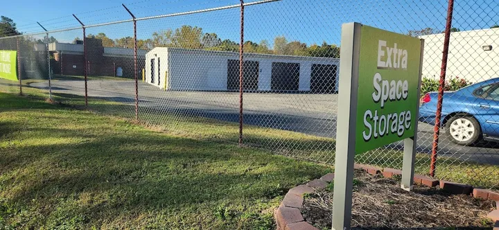 Extra Space Storage sign in front of a chain-link fence.