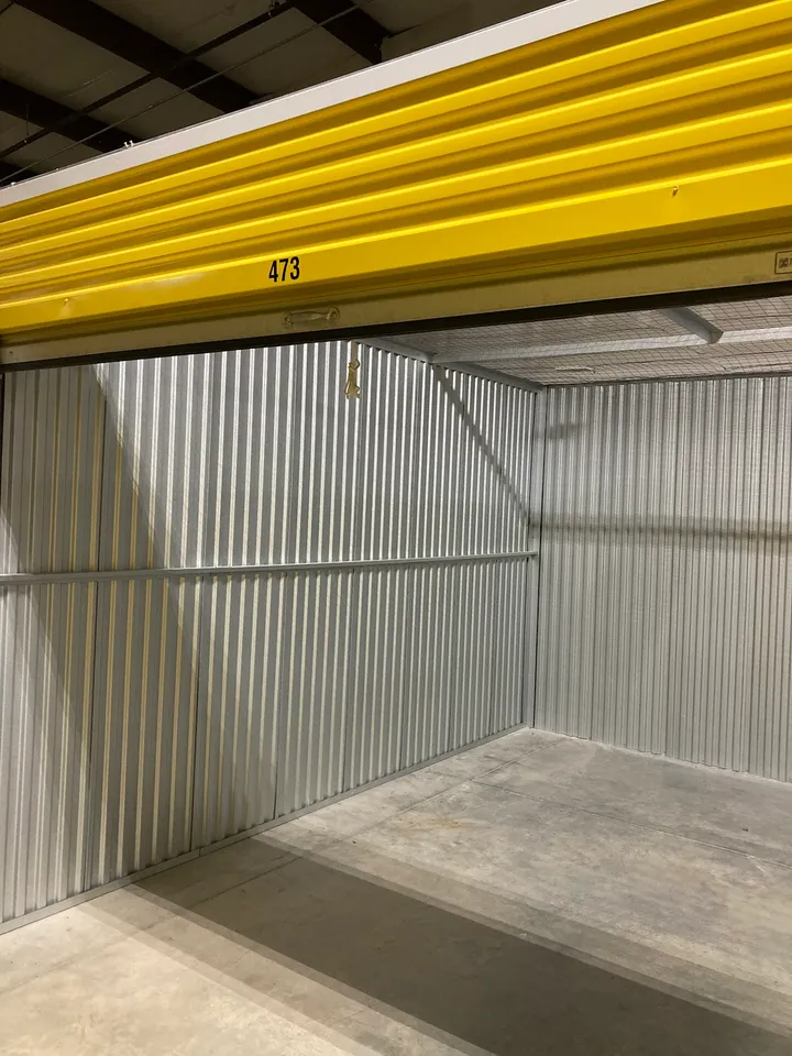 Empty storage unit interior with numbers 473 on the door
