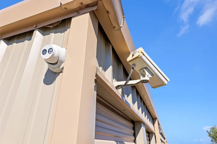 Security cameras mounted on the exterior of a storage building.