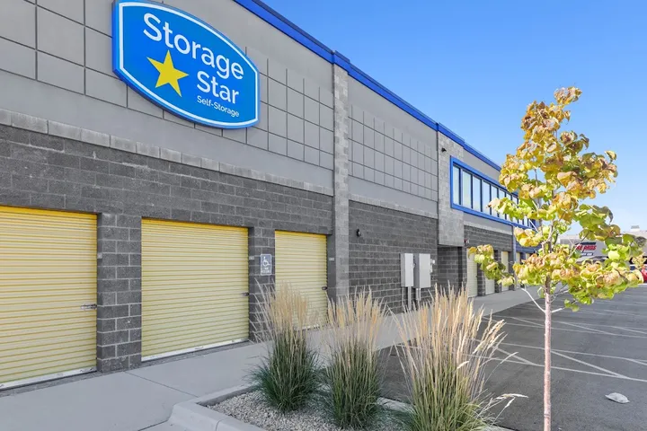 Exterior of building with Storage Star logo and yellow unit doors.