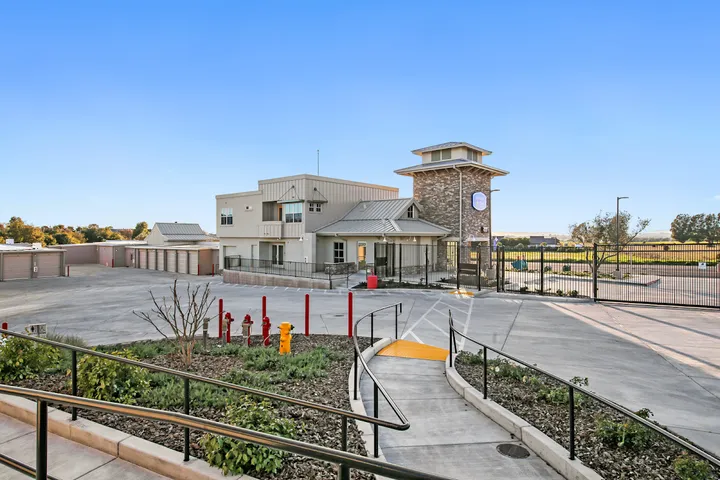 Exterior view of the main office building and security gate entrance.