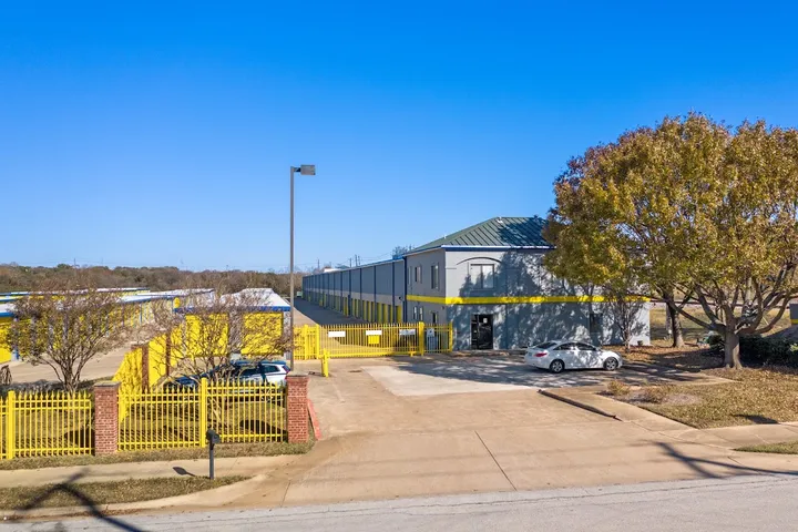 Front exterior of multi-story storage building with gated access.
