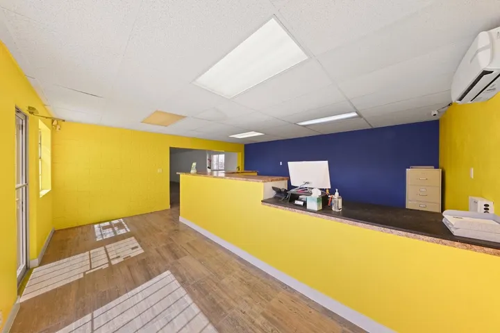 Customer service office with bright yellow and blue walls.