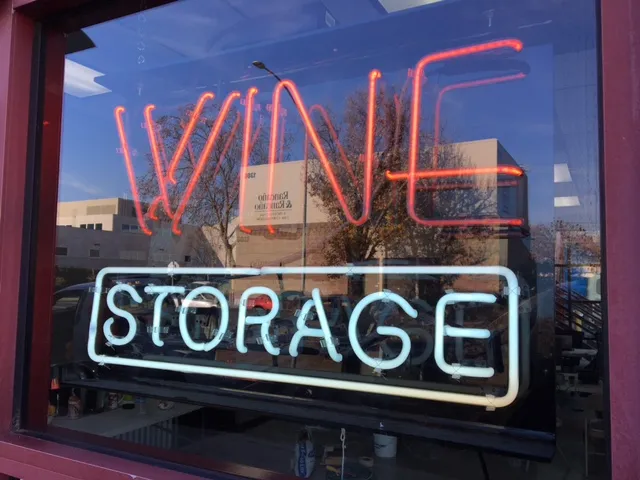 Neon sign in window reads 'Wine Storage'.