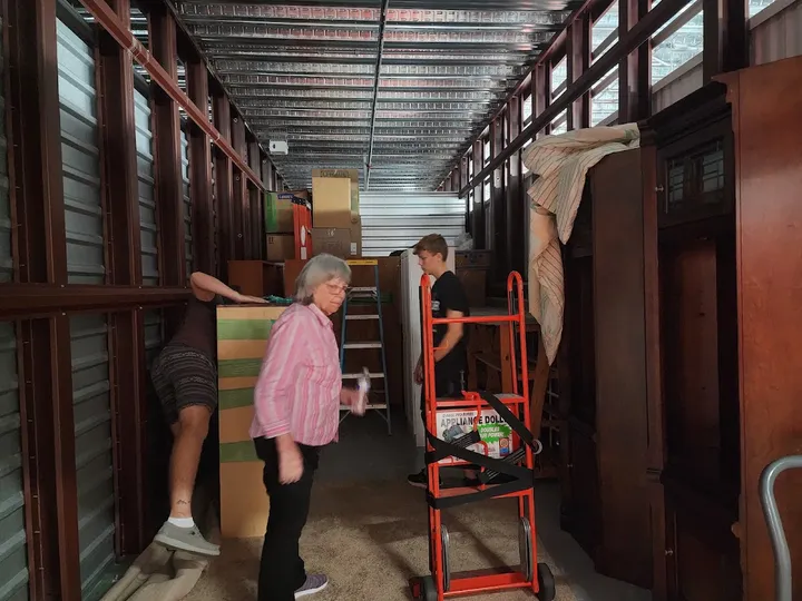 Customers moving items into a storage unit.