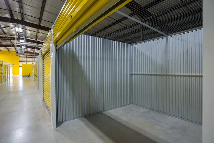 Interior of empty storage unit with overhead rolling door