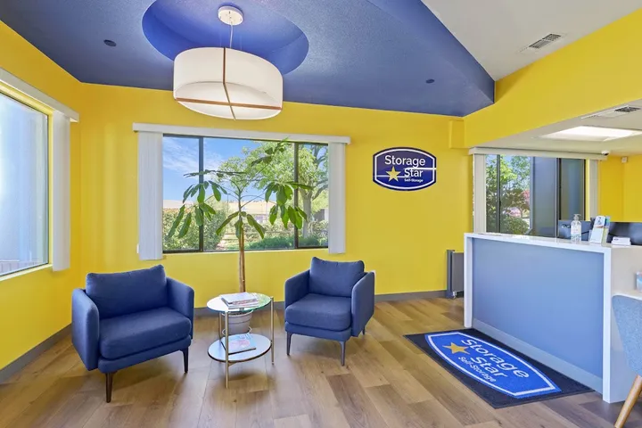 Vibrant blue and yellow customer waiting area with logo mat.