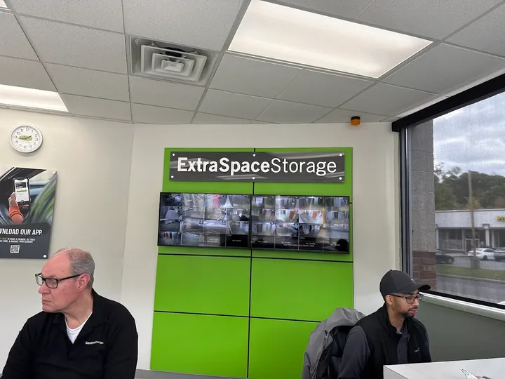 Office interior with security monitors and staff members