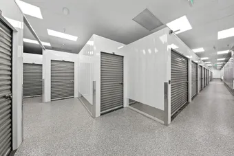 Clean, well-lit interior hallway with multiple storage units.