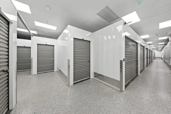 Clean, well-lit interior hallway with multiple storage units.