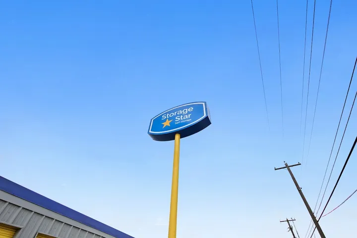 Blue and yellow 'Storage Star' freestanding sign against a blue sky.