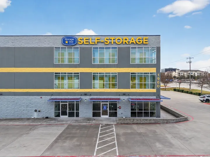 Front exterior of multi-story storage building with 'Self-Storage' sign.