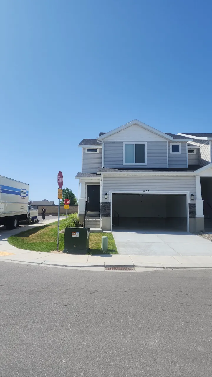 Residential building with a Penske moving truck in the background.