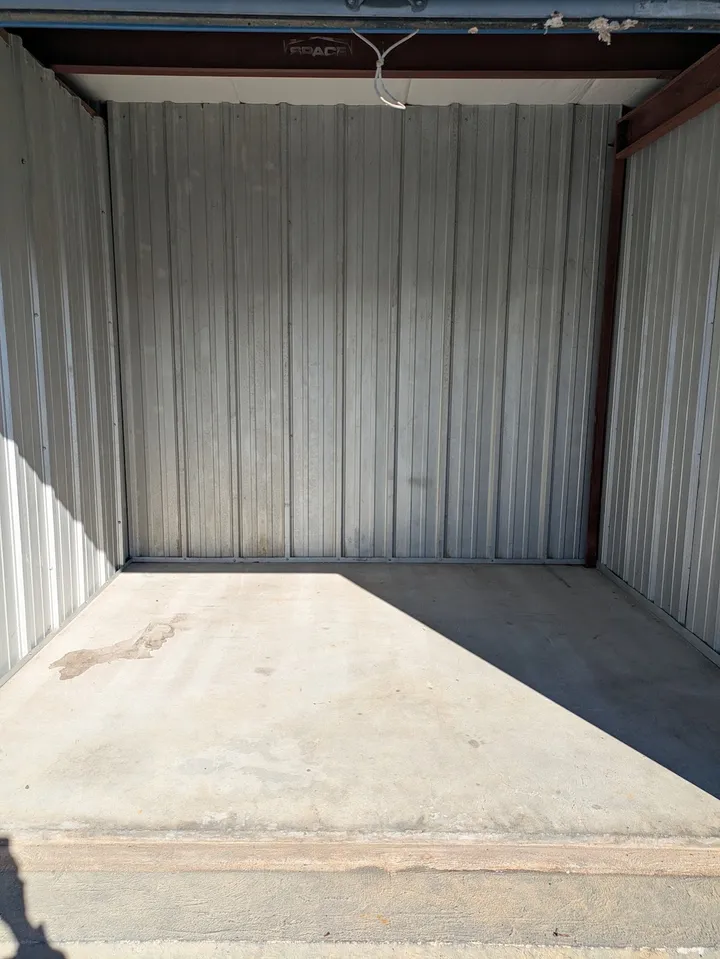 Interior of an empty outdoor drive-up storage unit.