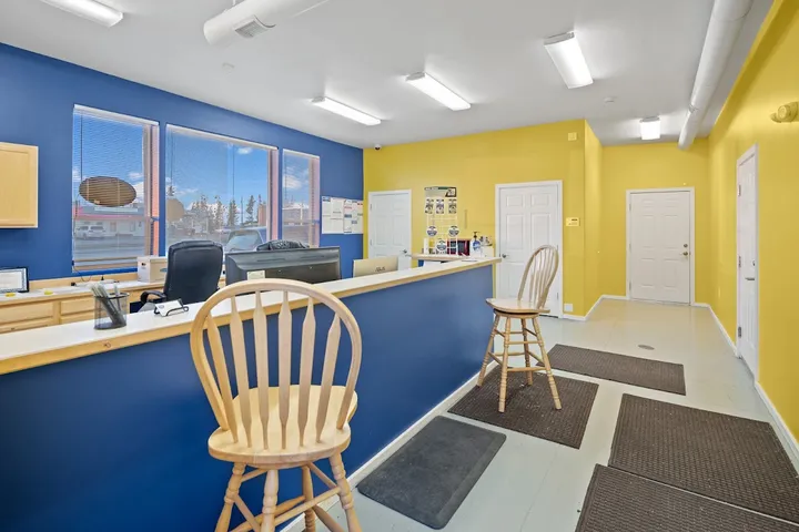 Customer service office interior with counter and chairs.
