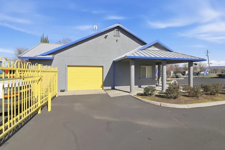 Exterior of facility office building and entrance gate.