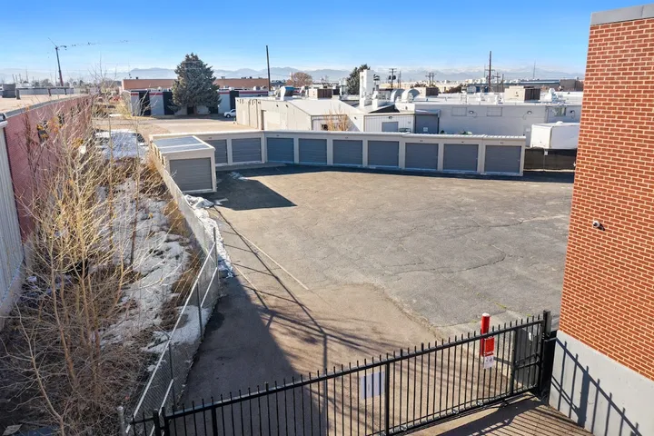 Outdoor drive-up storage units with fence and gate