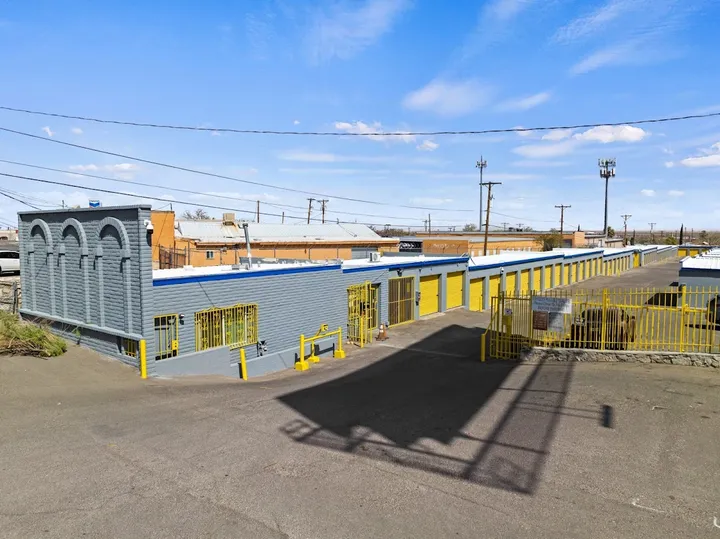 Outdoor drive-up access to storage facility with security gate.