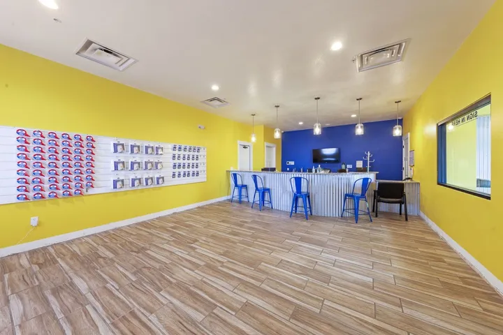 Office interior with counter, seating, and packing supplies display.