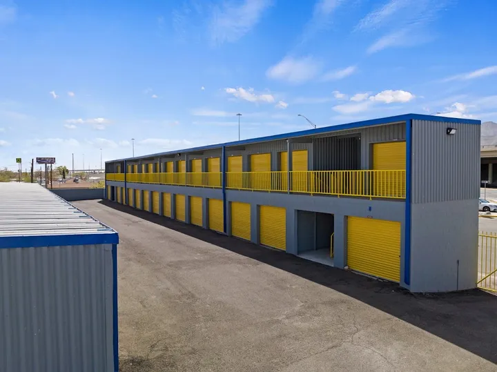 Two-story storage building with yellow doors and outdoor access.