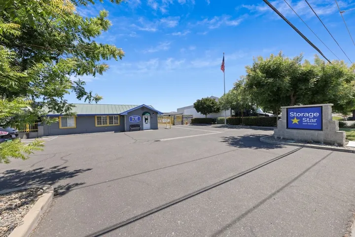 View of the office building, entrance, and Storage Star sign under a clear sky.